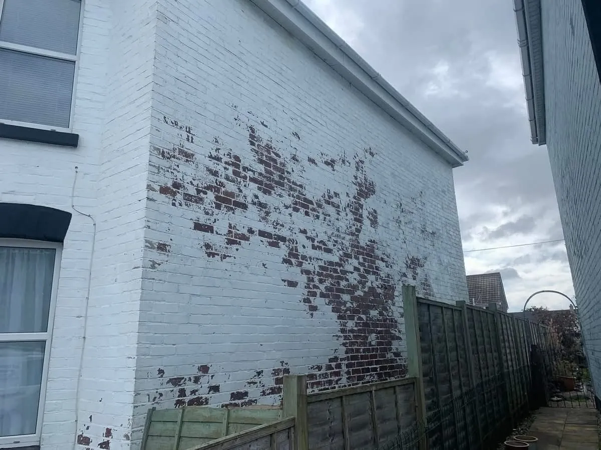 Peeling paint on a brick wall before redecoration in St Columb Major