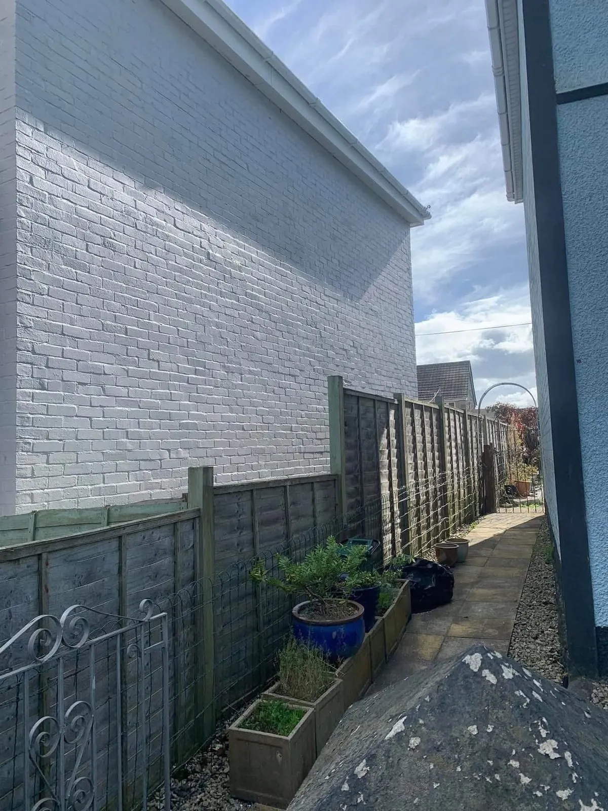Freshly painted brick wall after preparation and masonry paint in St Columb Major