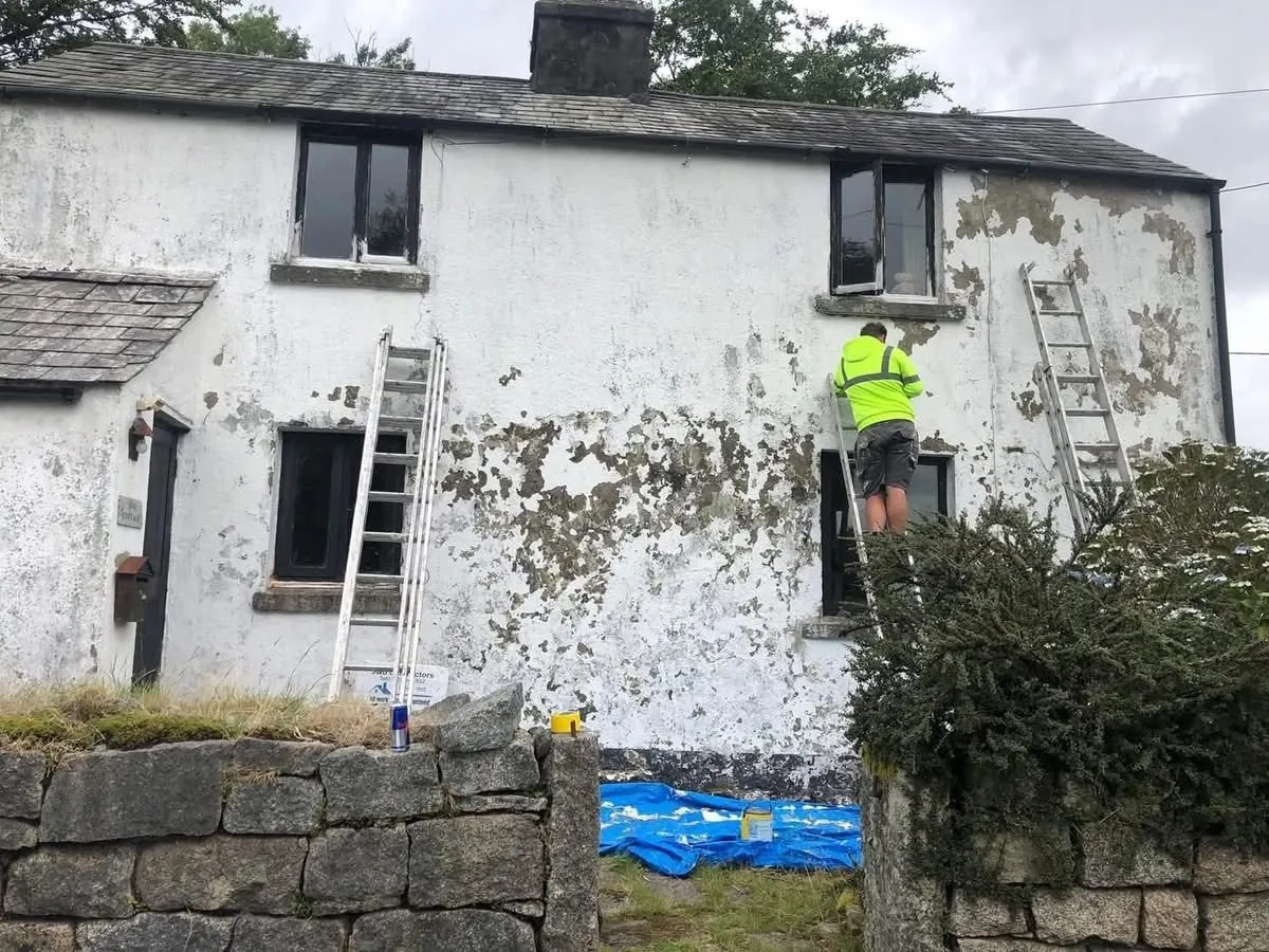 Cottage with blown, flaking render before repair in St Columb Major